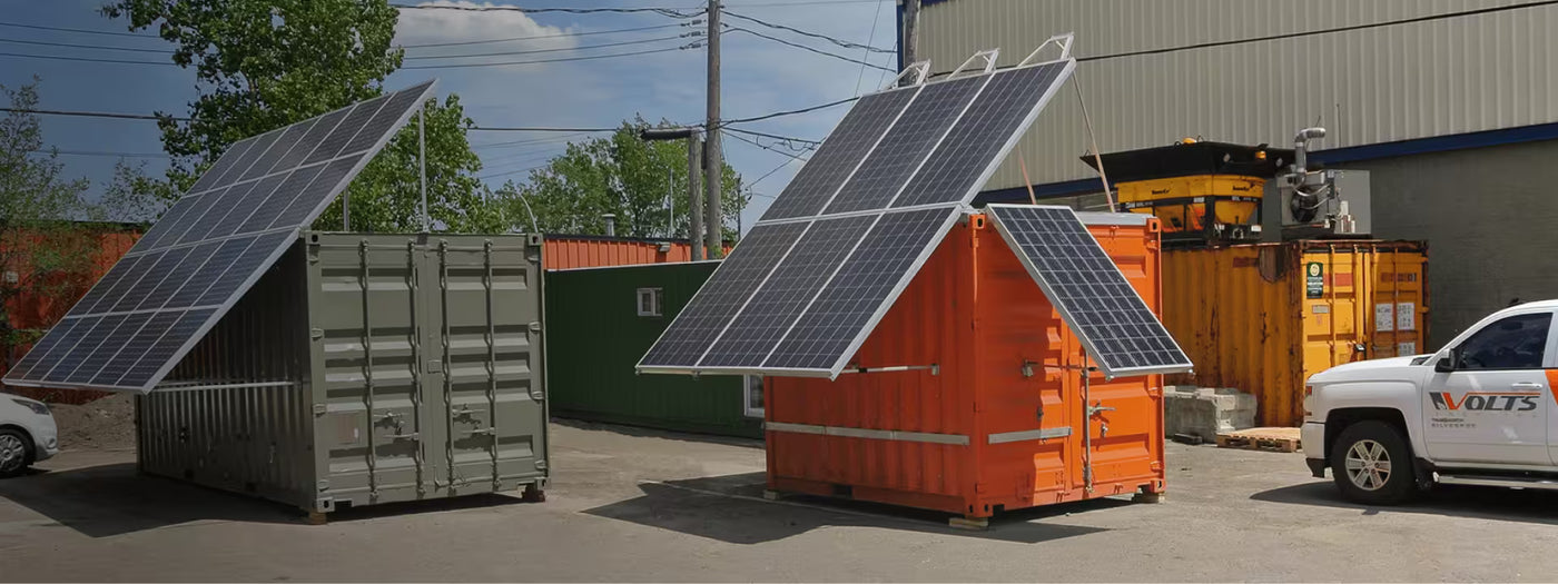Volts Energies green and orange autonomous solar containers with deployed photovoltaic panels at their Quebec facility