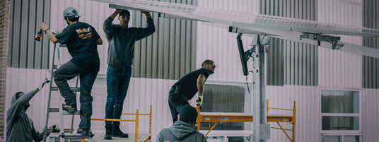 Volts Energies crew installing solar racking system on commercial building