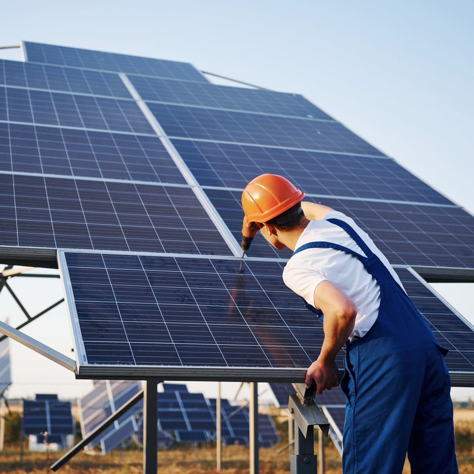 Technician installing bifacial solar panels