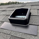 Roof-Mounted Solar PV Junction Box on a shingled roof with trees in the background
