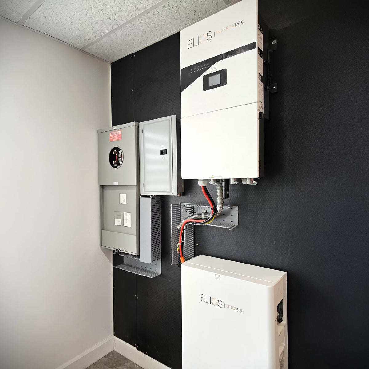 Elios Inversa 1510 hybrid solar inverter charger installed with a Litio 16.0 battery and electrical panels.