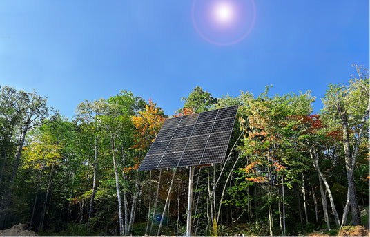 Pole-mounted solar panel on wooded property in Canada