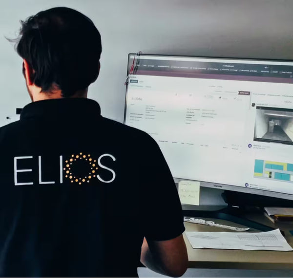 Elios Energy technician monitoring a solar energy system surveillance software on a computer screen