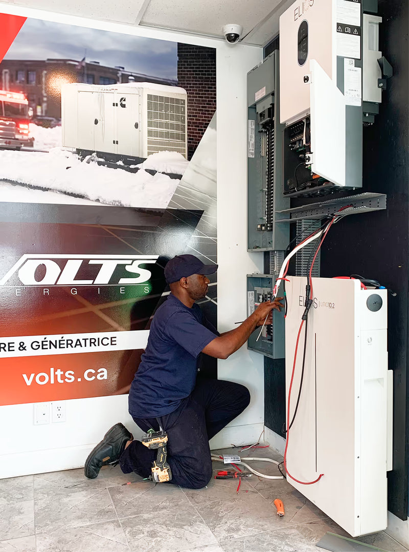 Volts certified technician installing solar battery system at Volts showroom
