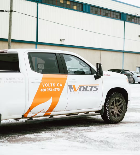Volts Energies branded service pickup truck parked in winter conditions, serving clients across Quebec