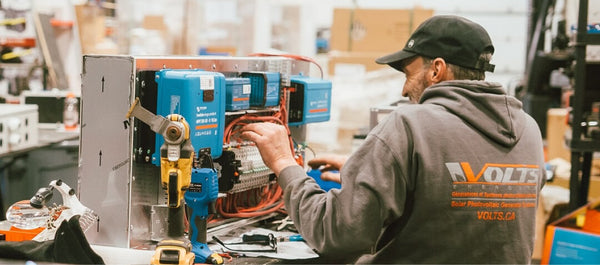 Technician working on the interior build of a custom camper van conversion at the Volts Energies facility
